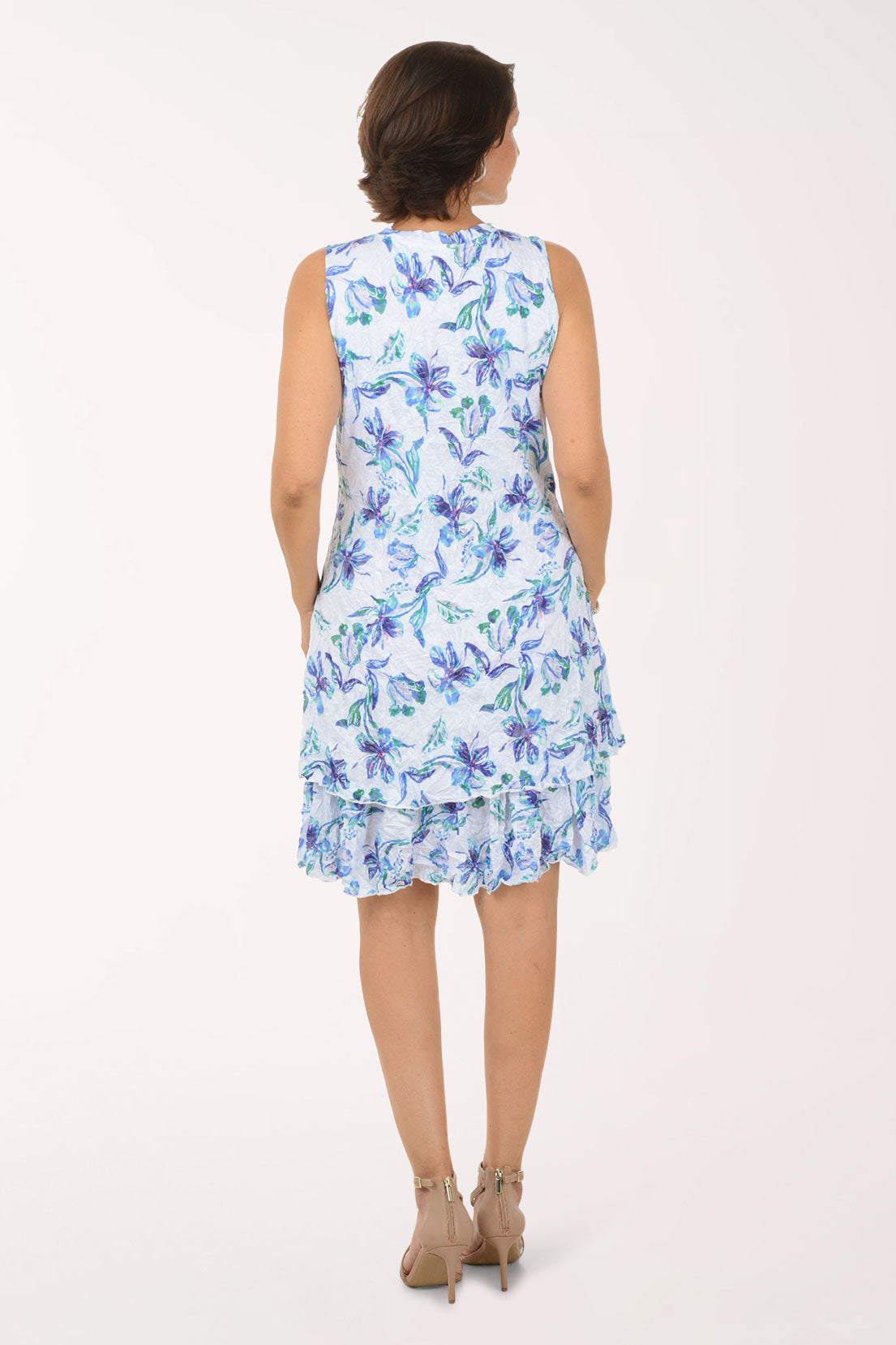 Woman wearing a blue floral dress on a white background
