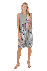 A woman wearing a grey sleeveless dress with a multi color pattered and left hip pocket.