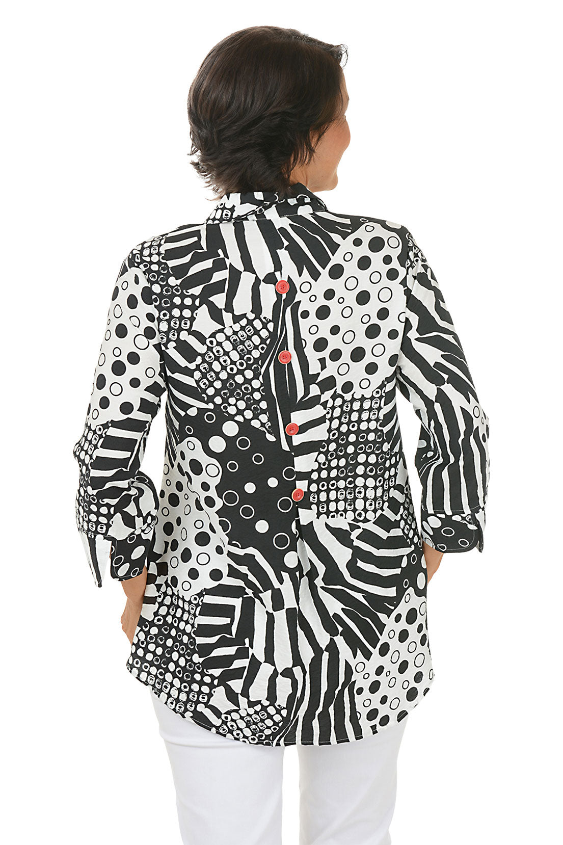 Woman wearing a black and white zebra patterned blouse with red buttons on a white background. Back shot.