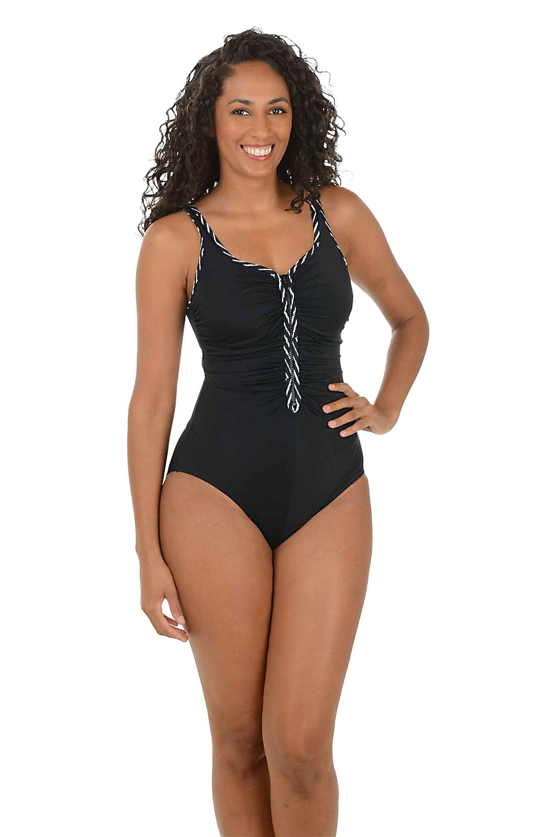 Woman wearing a black swimsuit with black and white decorative straps on a white background.