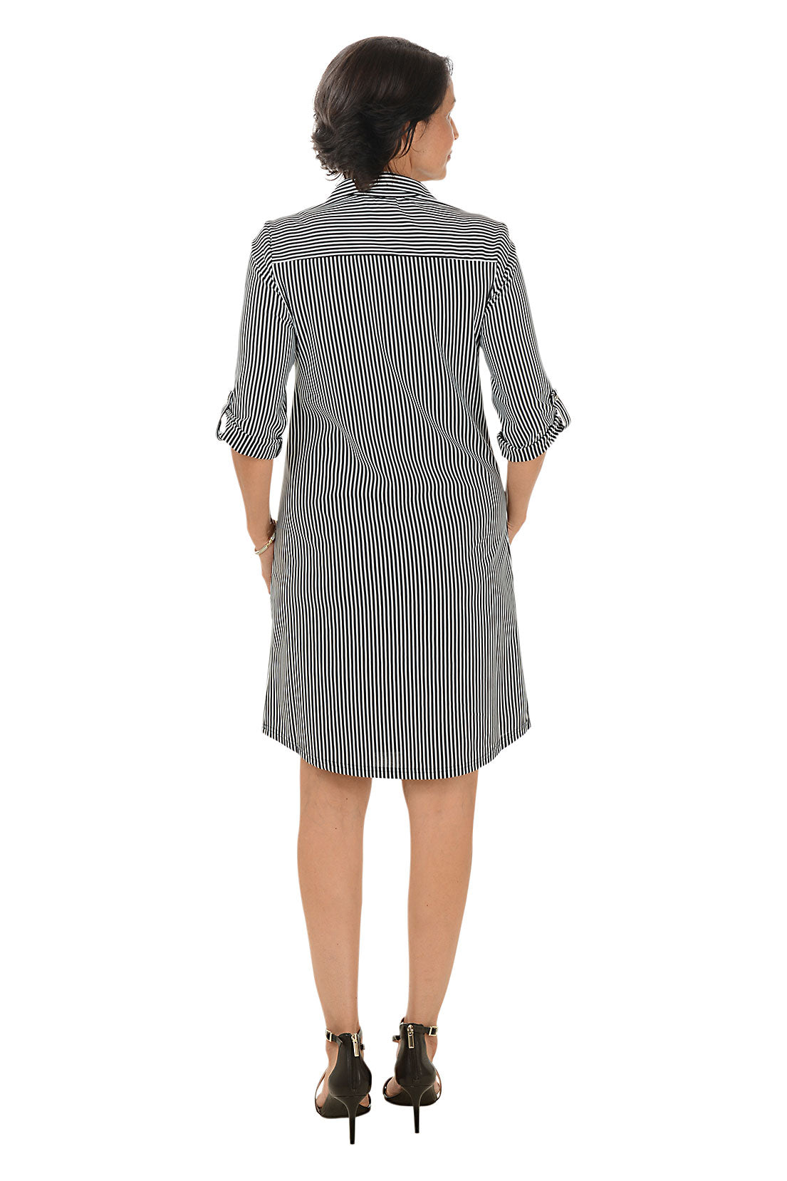 Woman wearing a black and white stripe dress on a white background. Back shot.