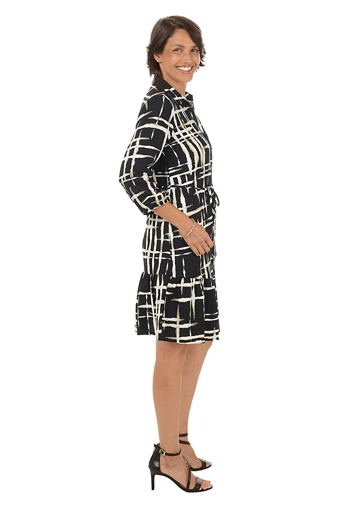 Woman wearing a zebra print dress on a white background. Side shot.