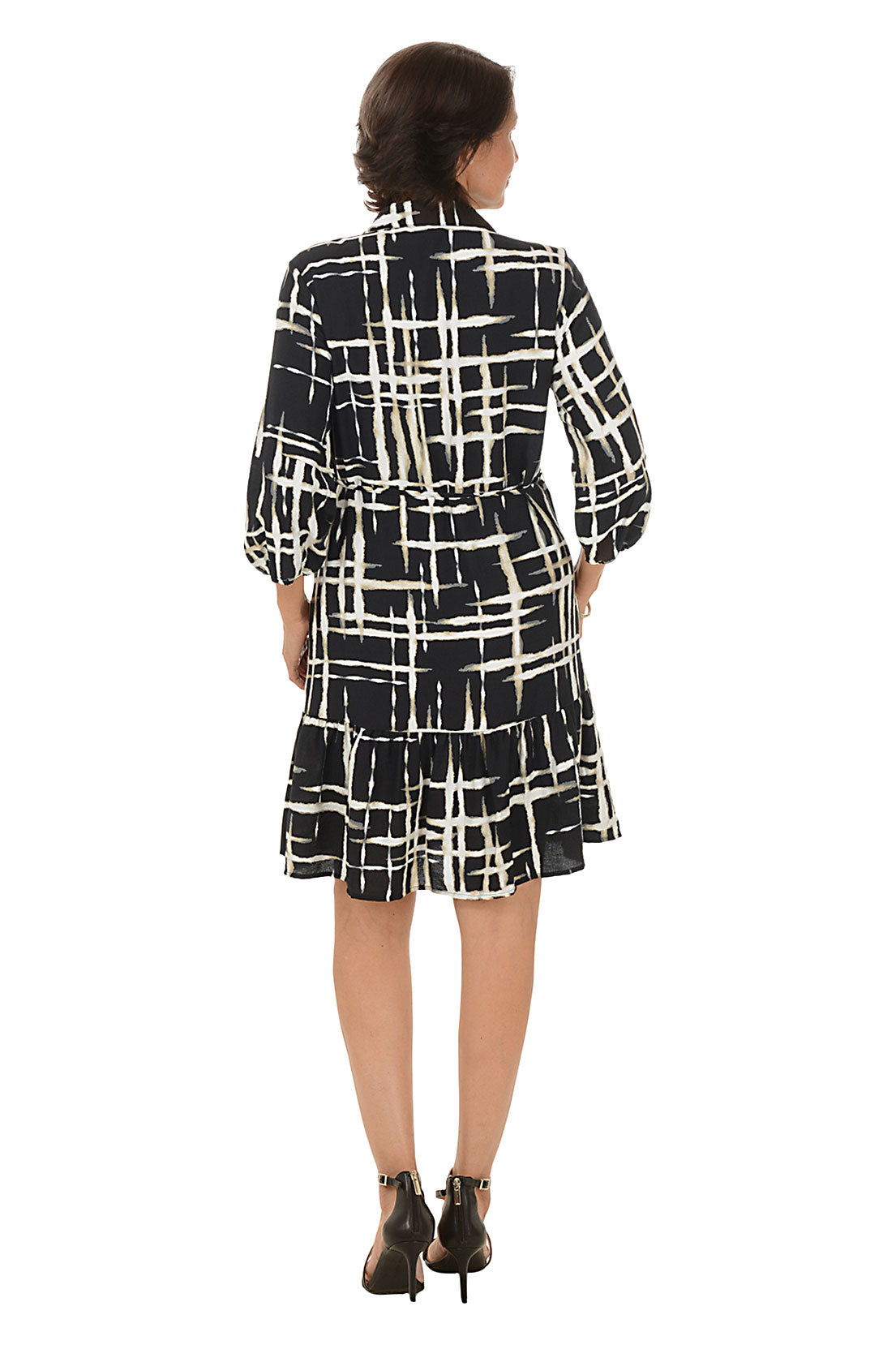Woman wearing a zebra print dress on a white background. Back shot.