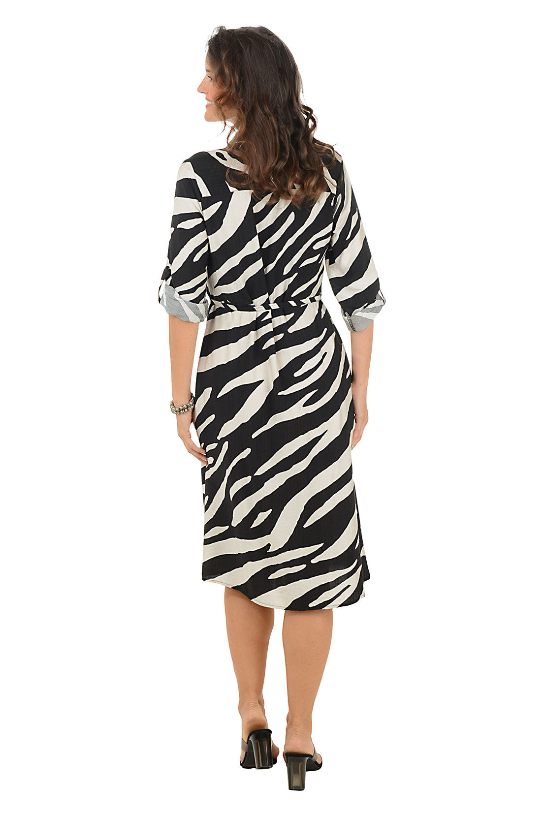 Woman wearing a zebra print dress on a white background. Back shot.