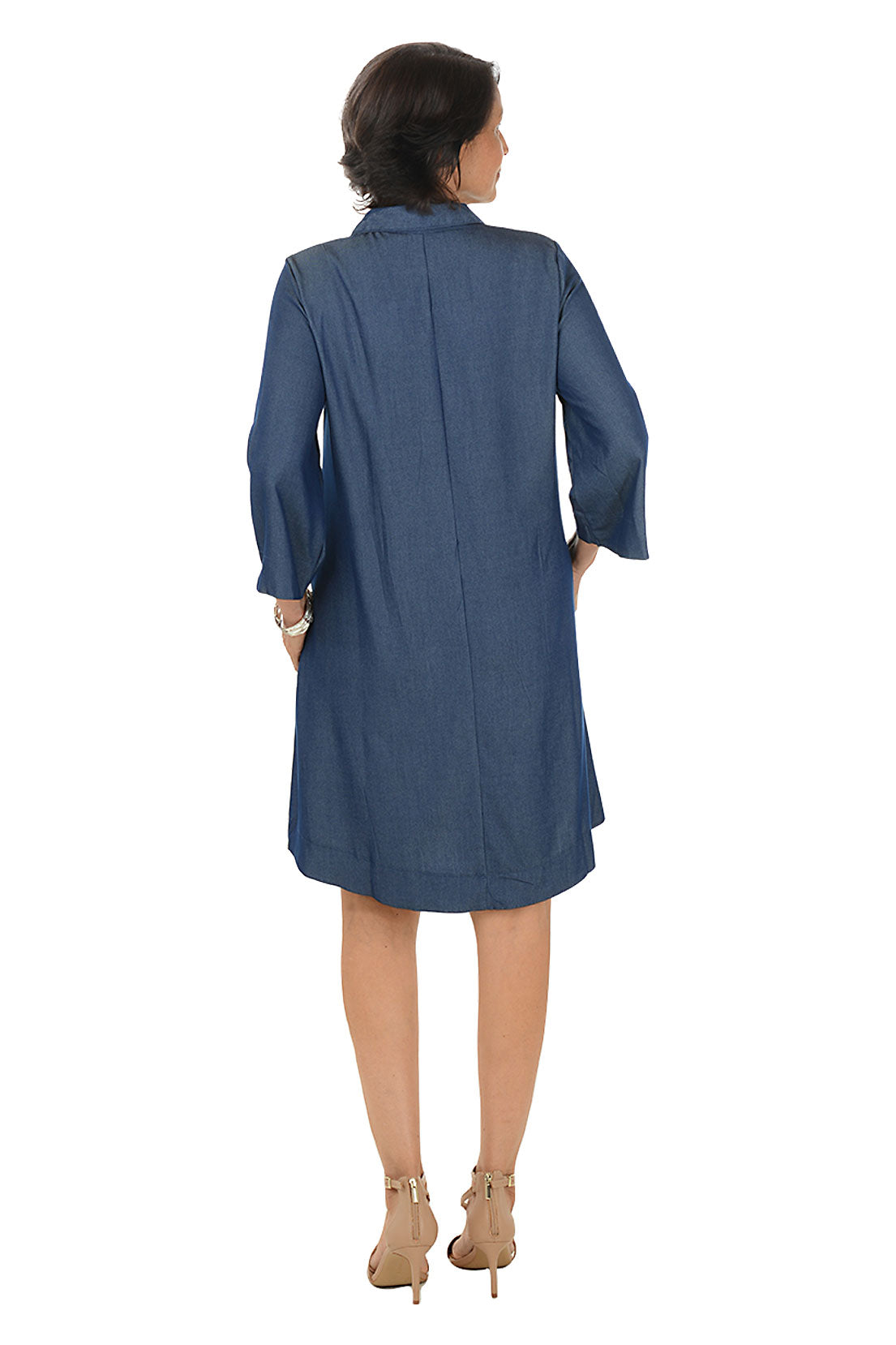 Woman wearing a blue dress on a white background. Back shot.