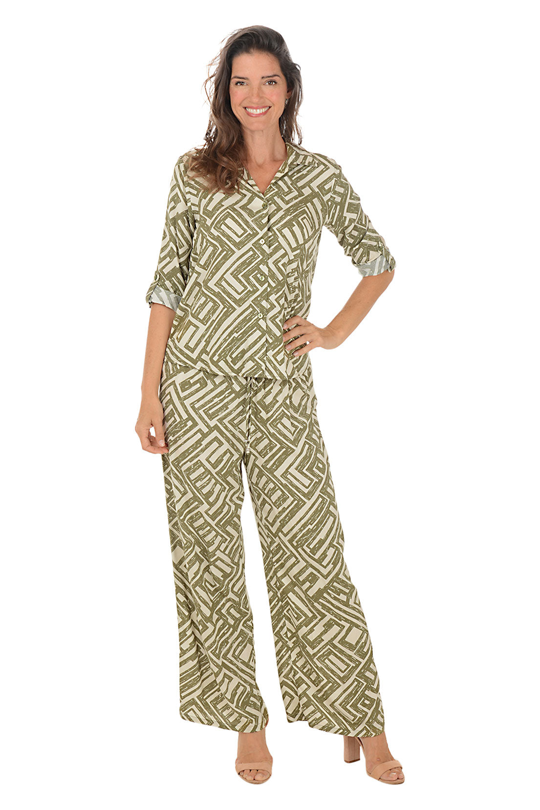Woman wearing a green patterned lounge set on a white background.
