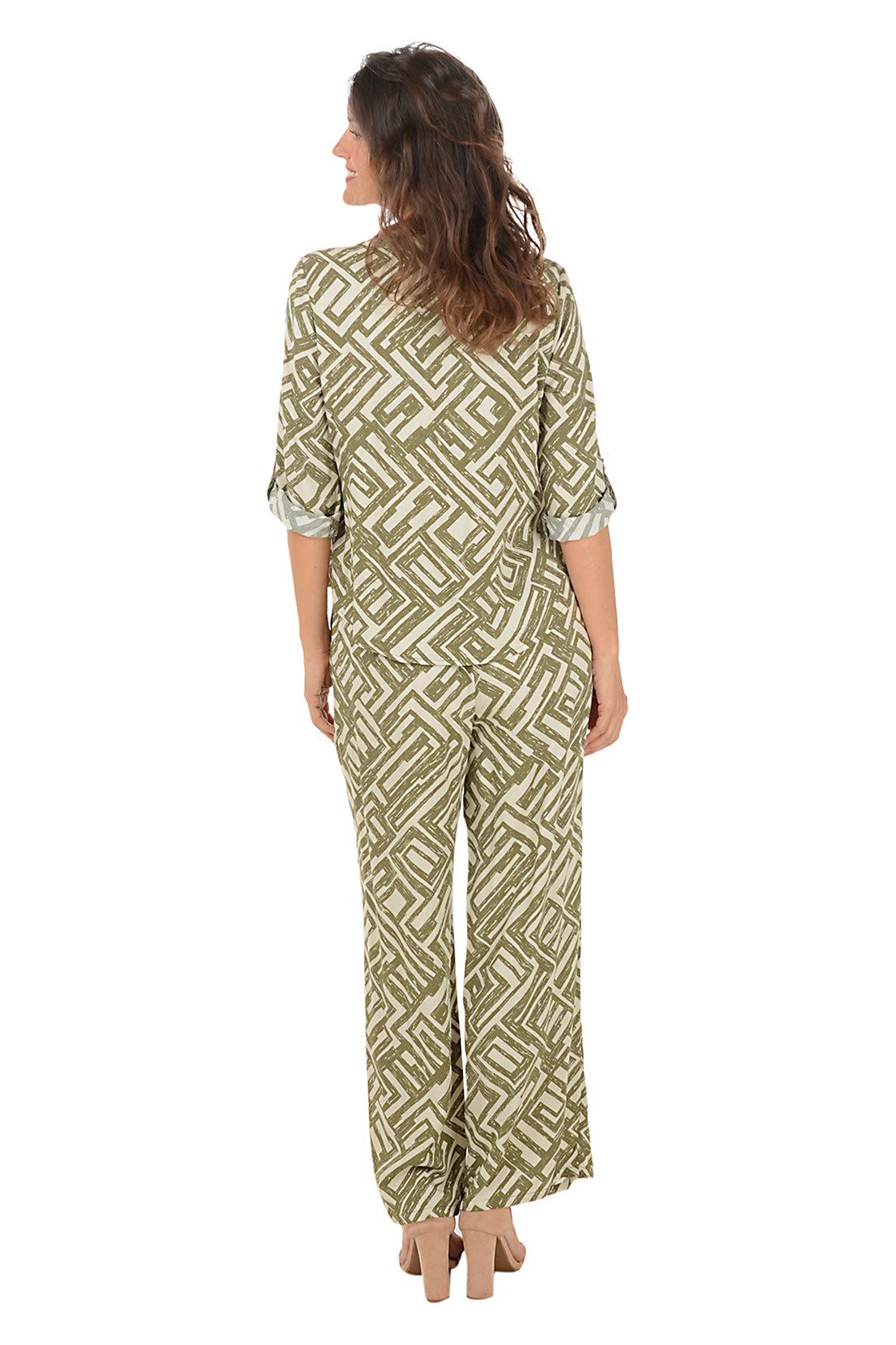 Woman wearing a green patterned lounge set on a white background. Back shot.