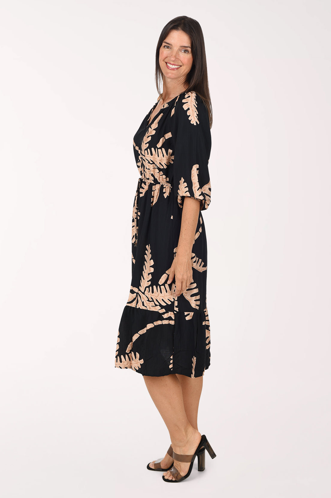 Side view of the Coconut Palm Cinched Waist Midi Dress showing the ruffle hem