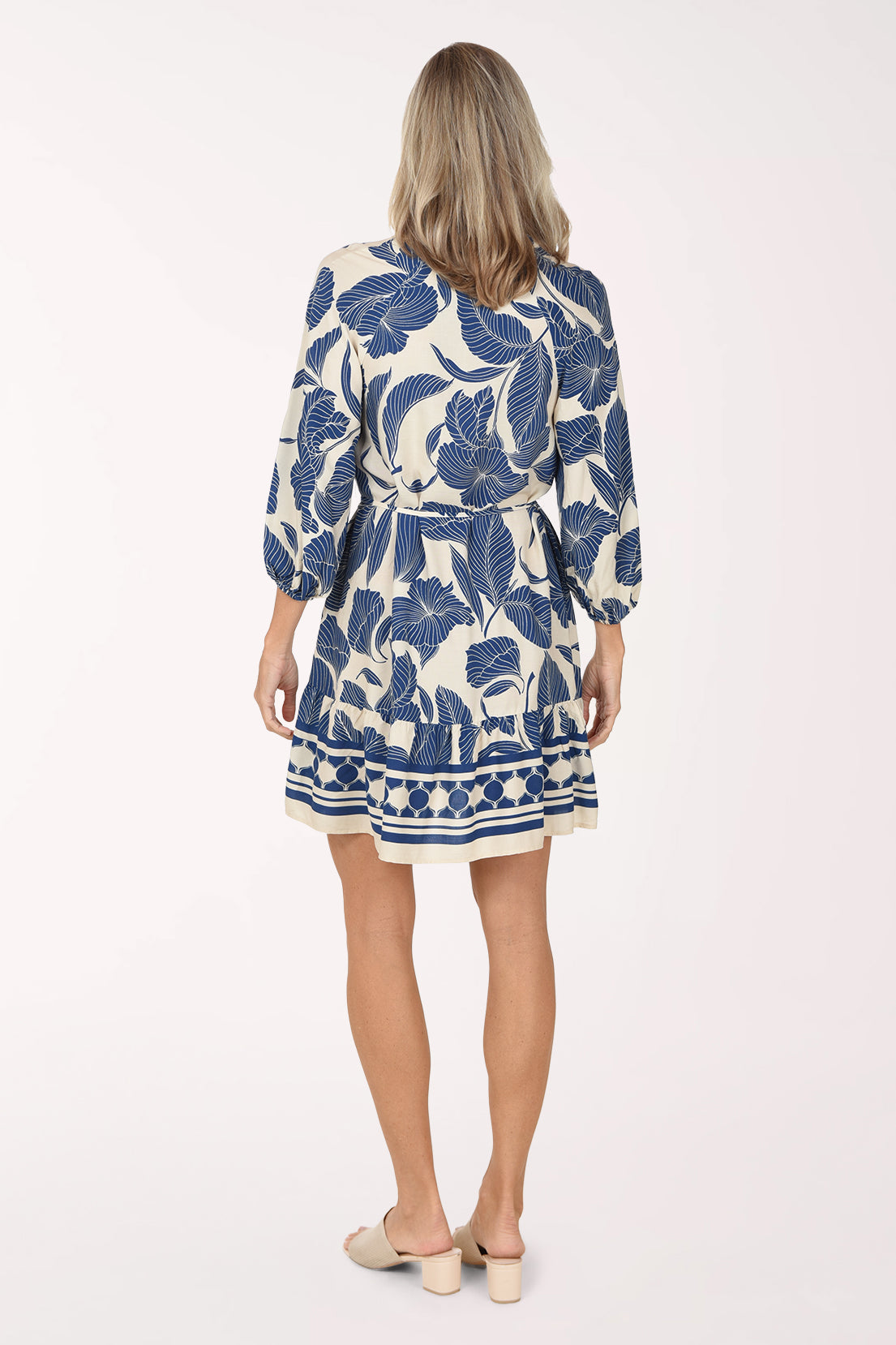Back view of the Trumpet Flower Belted Dress in cream and royal blue