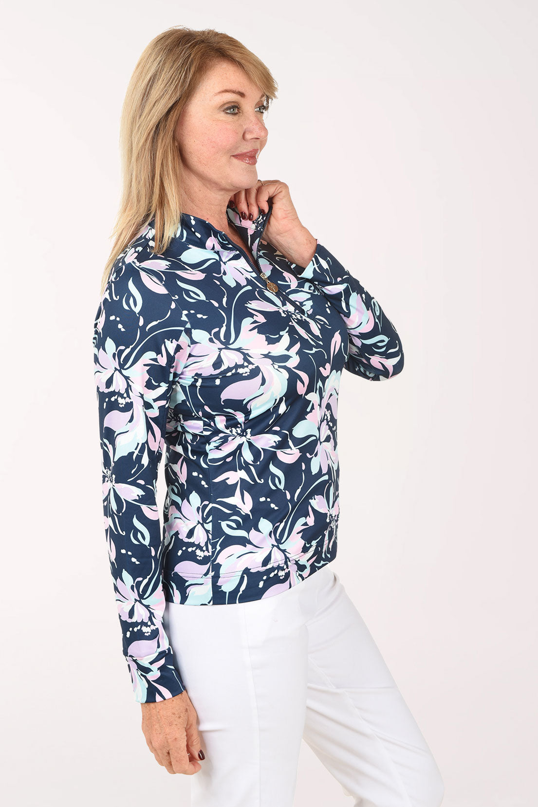 Woman wearing a floral patterned shirt on a white background