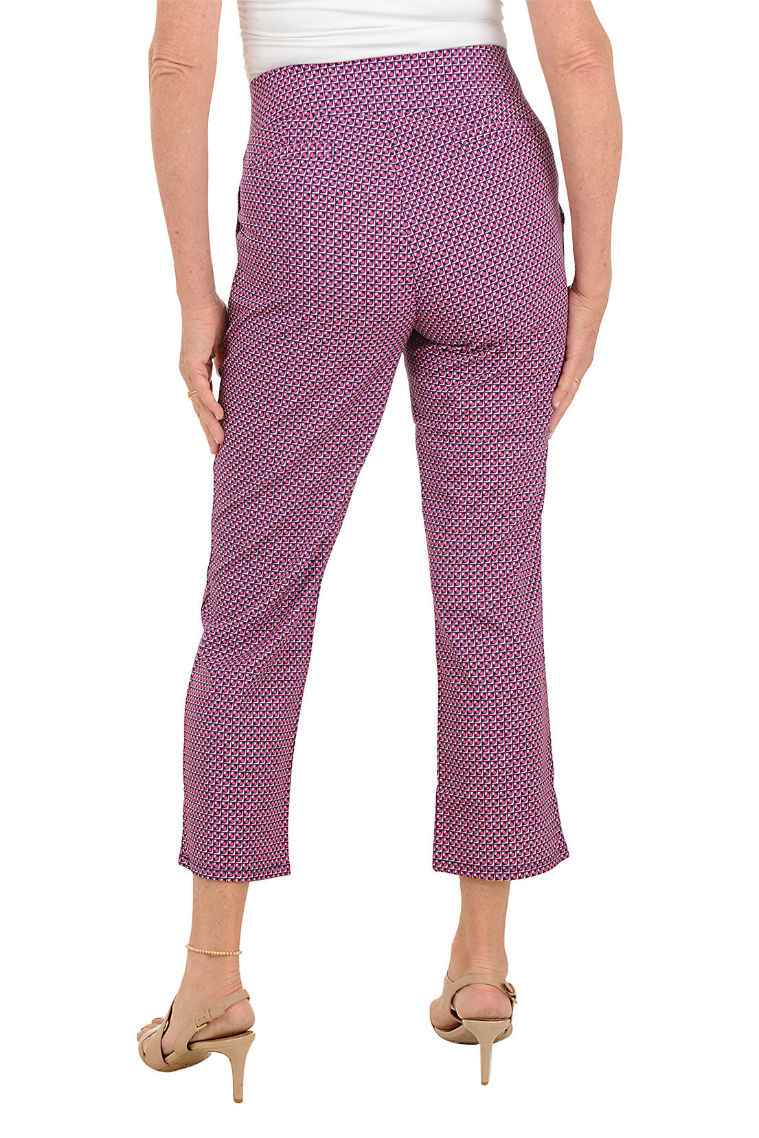 A woman wearing a cropped trouser pant in a pink multi floral print. Back shot.