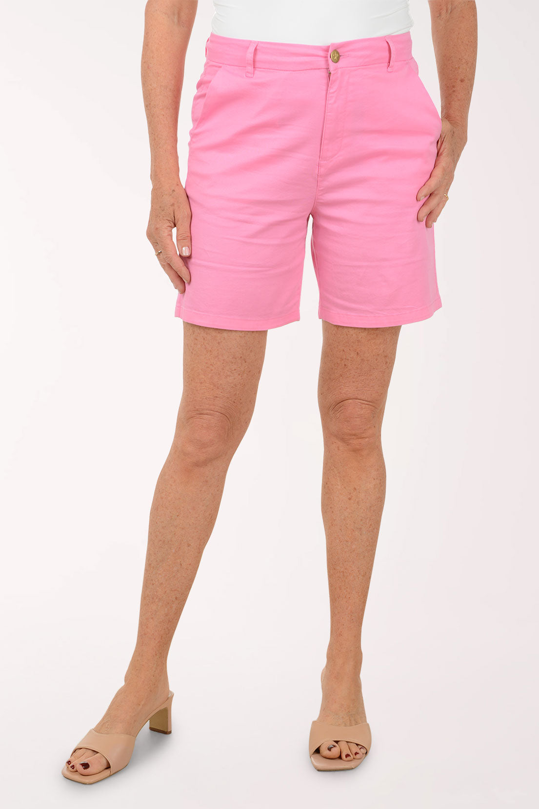 Person wearing pink shorts on a white background