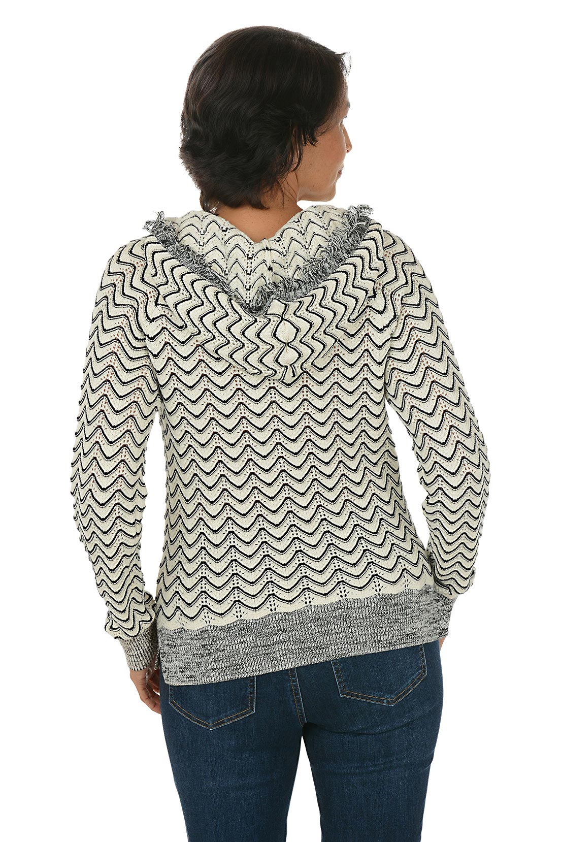 Woman wearing a zigzag patterned hoodie on a white background. Back shot.