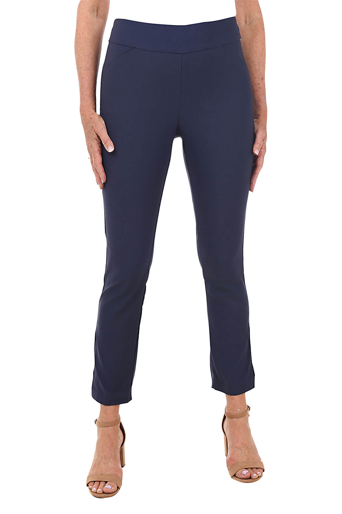 A front shot of a model wearing a pair of deep blue ankle pants with an elastic waistband, dual front pockets, and side slits on the hemline. The pants are pull-on style with no visible zipper.