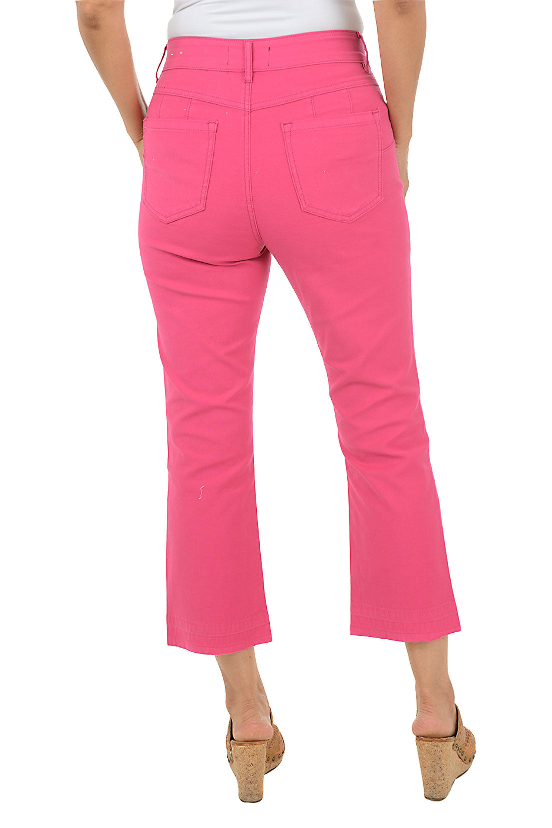Person wearing bright pink pants on a white background. Back shot.