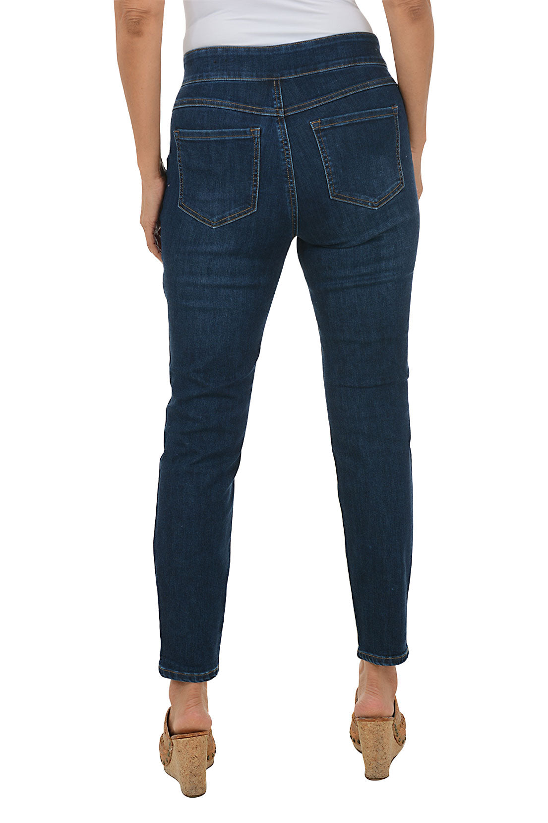 Person wearing dark blue jeans on a white background. Back shot.