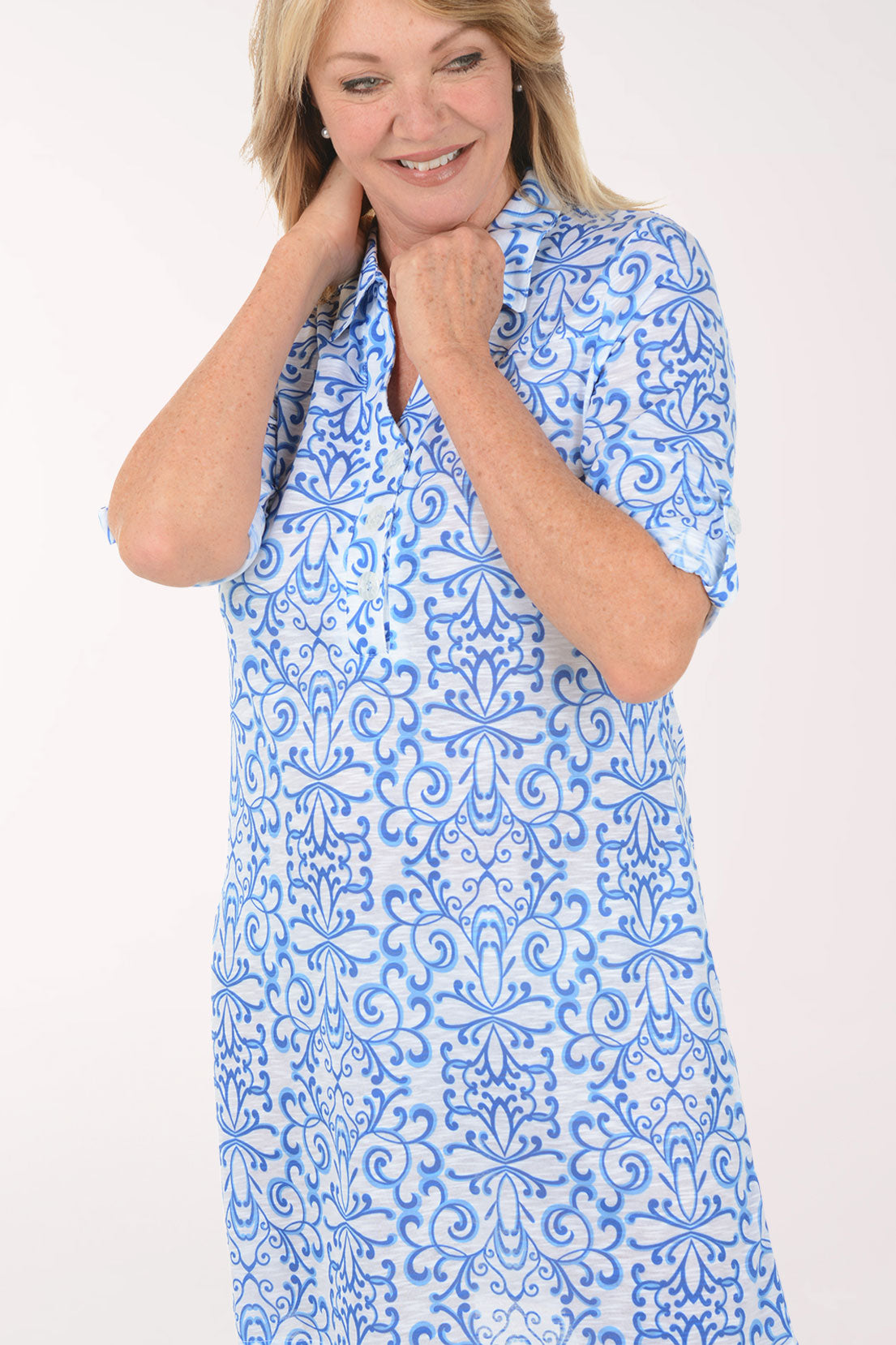 Woman wearing a blue floral dress on a white background