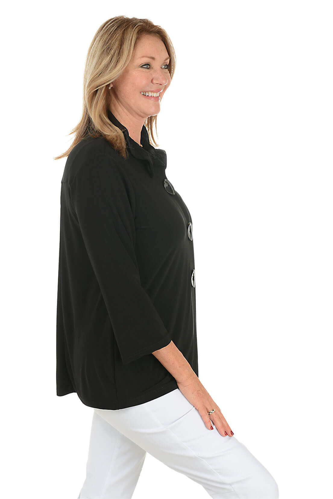 Woman wearing a black coat with buttons on a white background. Side shot.