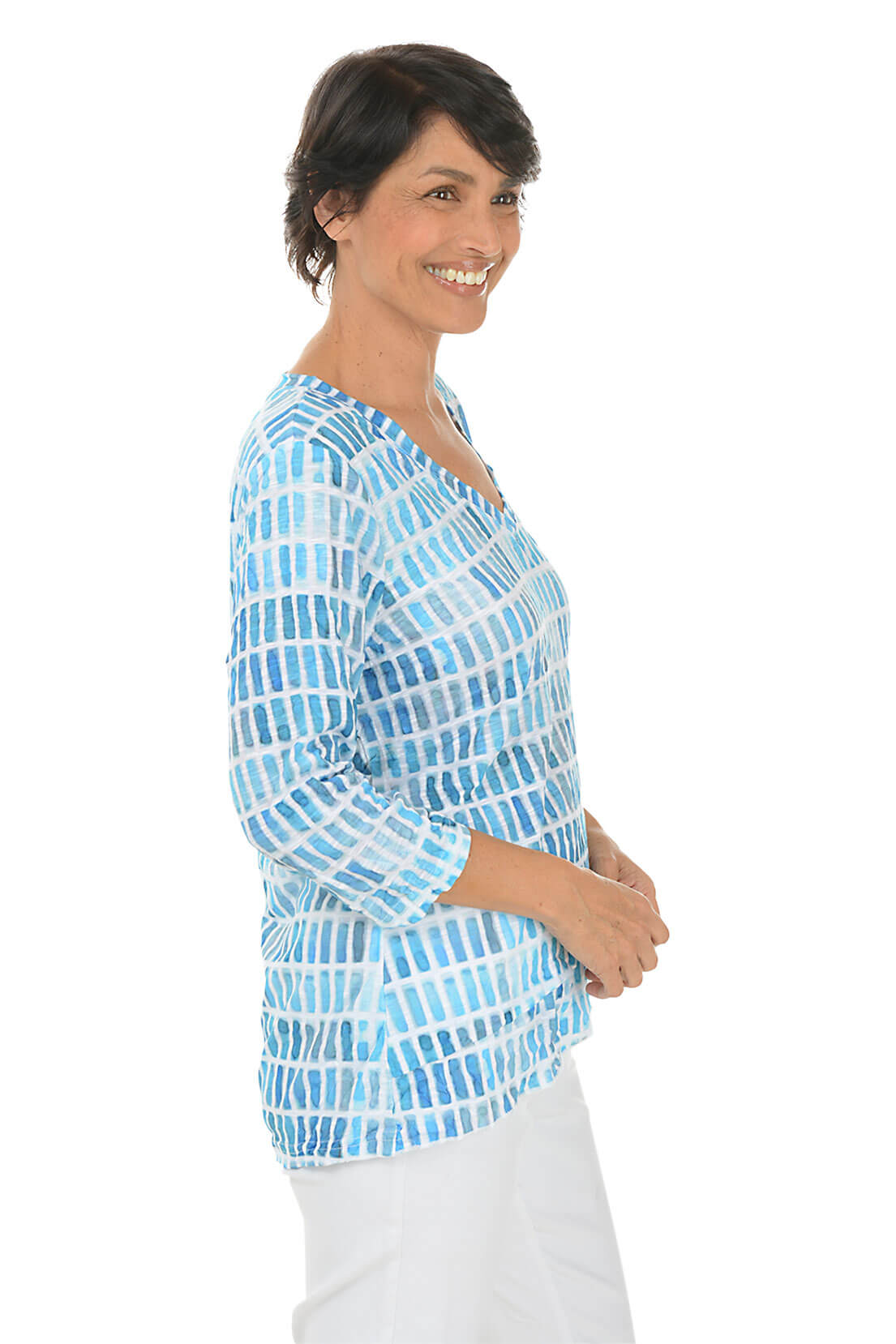 Woman wearing a blue patterned top on a white background