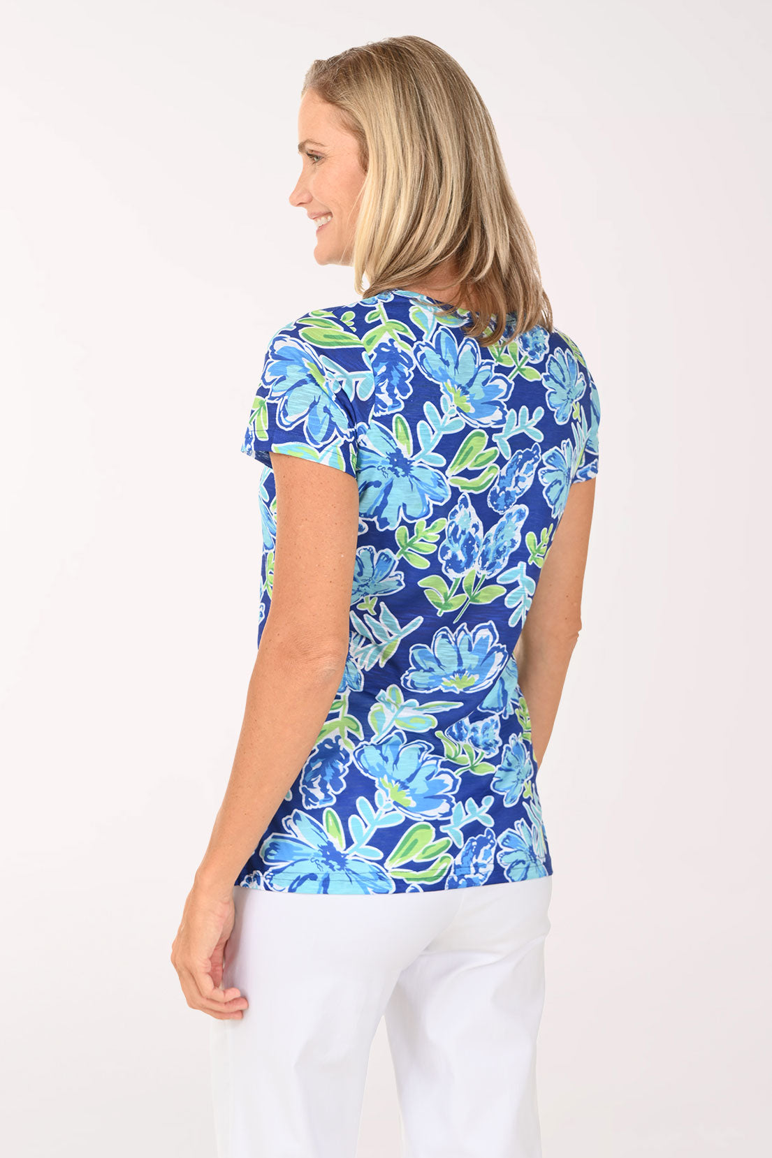 Woman wearing a blue and green top with hydrangeas on it