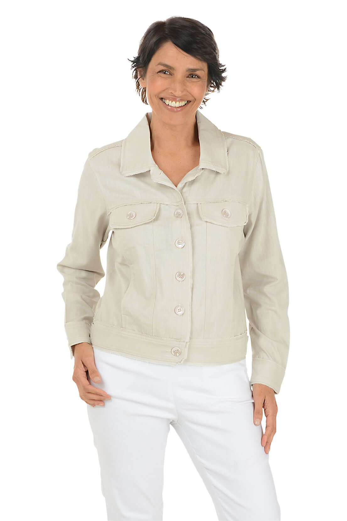 Woman wearing a light-colored jacket and white pants on a white background.