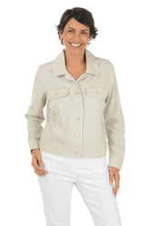 Woman wearing a light-colored jacket and white pants on a white background.