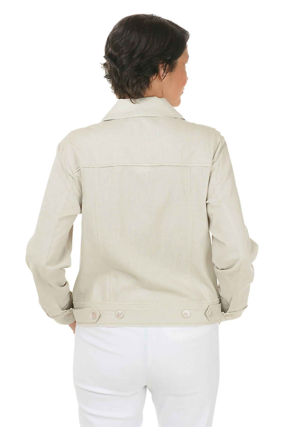 Woman wearing a light-colored jacket and white pants on a white background. Back shot.
