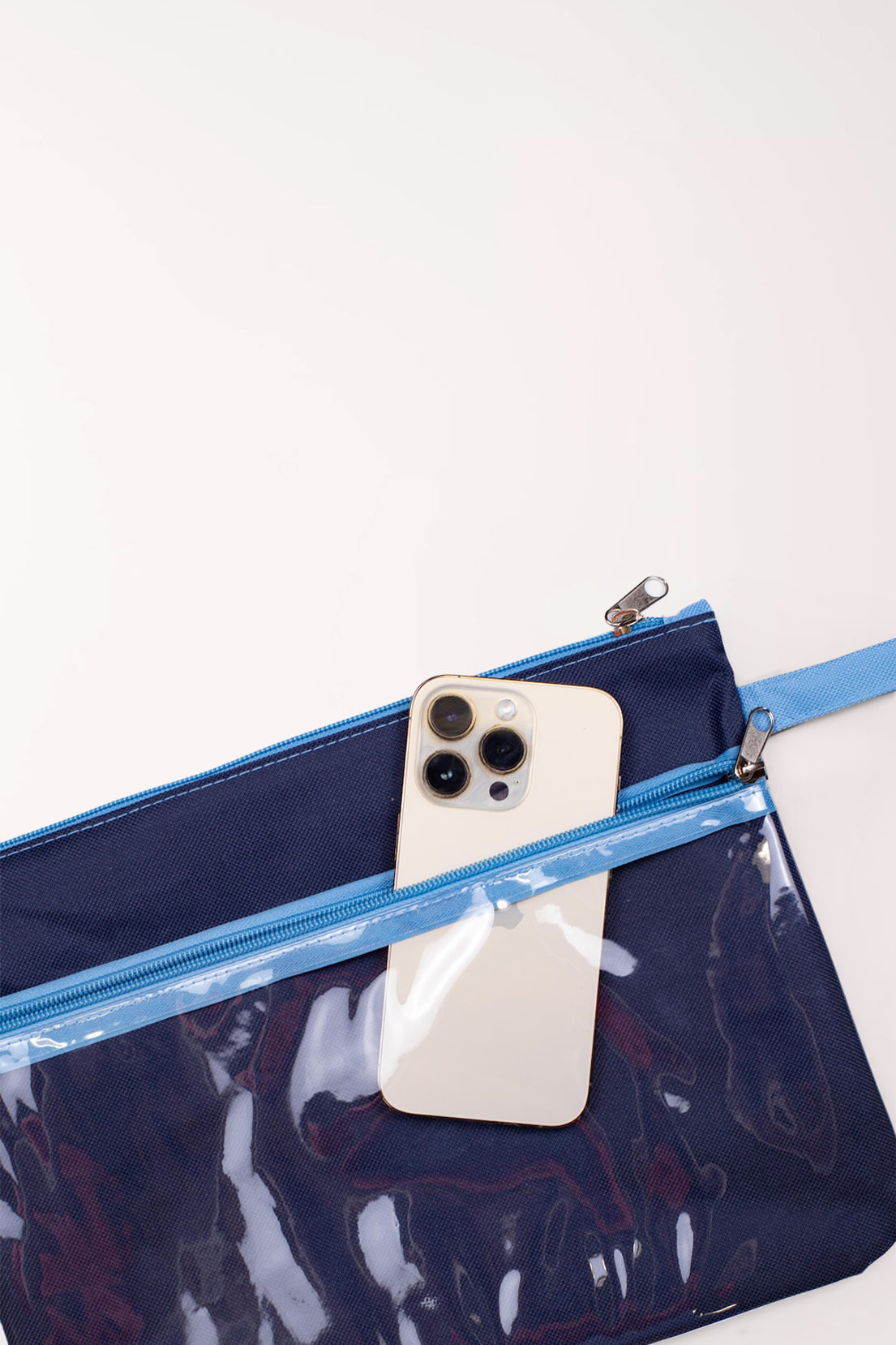 Open San Blas Stripe Wet/Dry Bag showing the navy inner zippered section holding a phone
