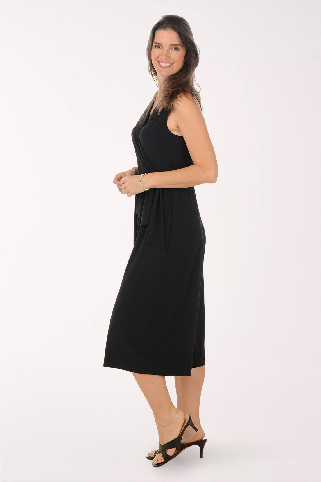 Woman wearing a black jumpsuit on a white background