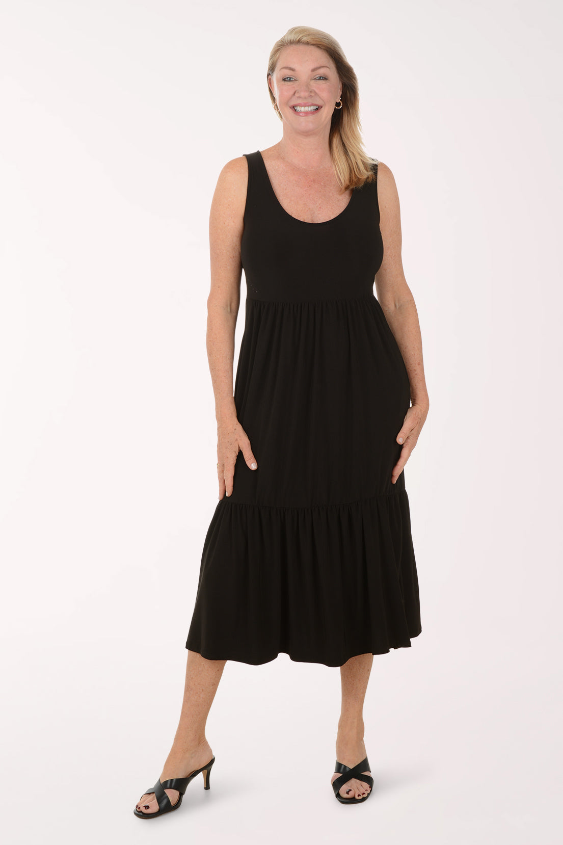 Woman wearing a black sleeveless dress on a white background