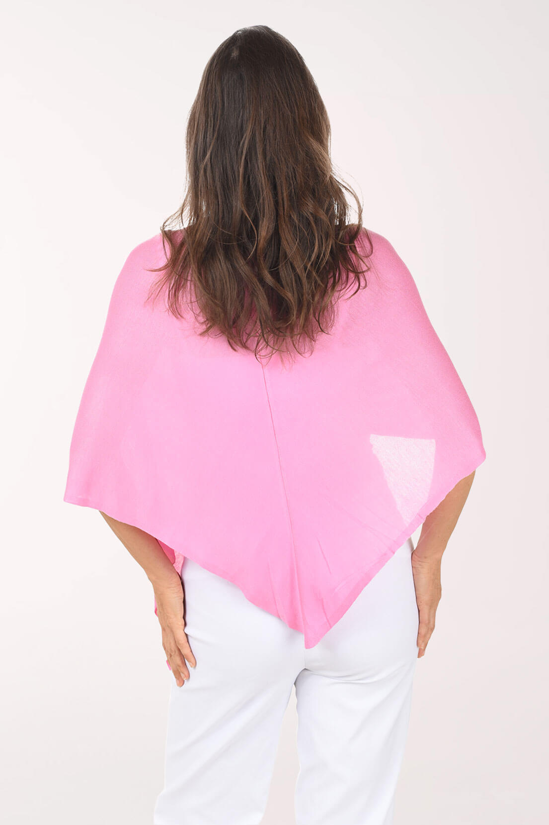 Person wearing a pink shawl over shoulders on a white background
