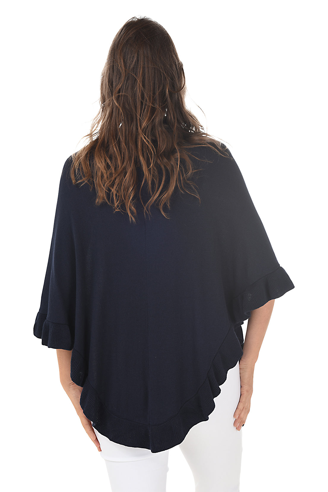 A woman wearing a black open front wrap sweater with ruffled rib-knit trim over a white top and white pants. Back shot.
