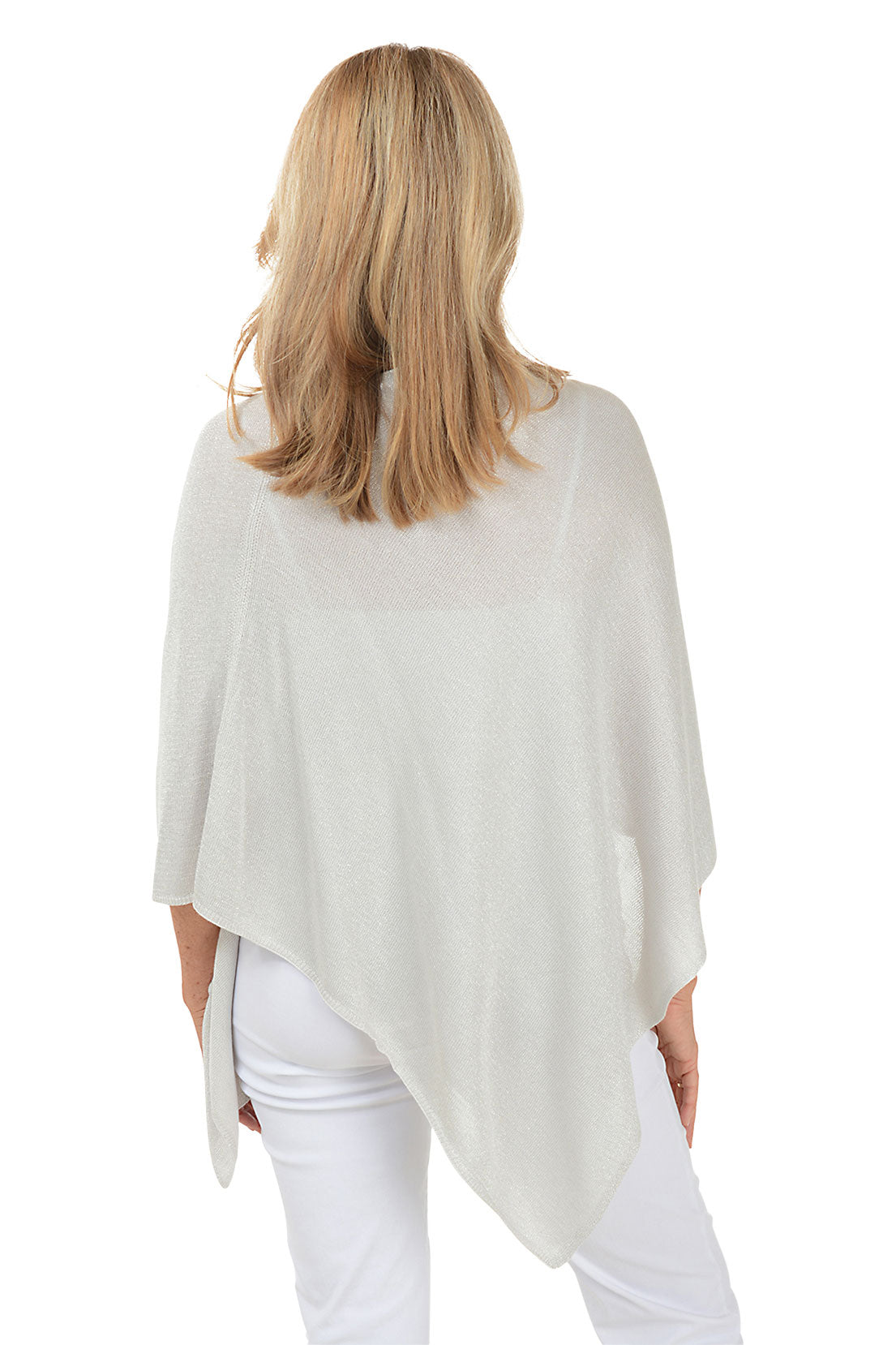 Woman wearing a light gray poncho over a white outfit on a white background. Back shot.