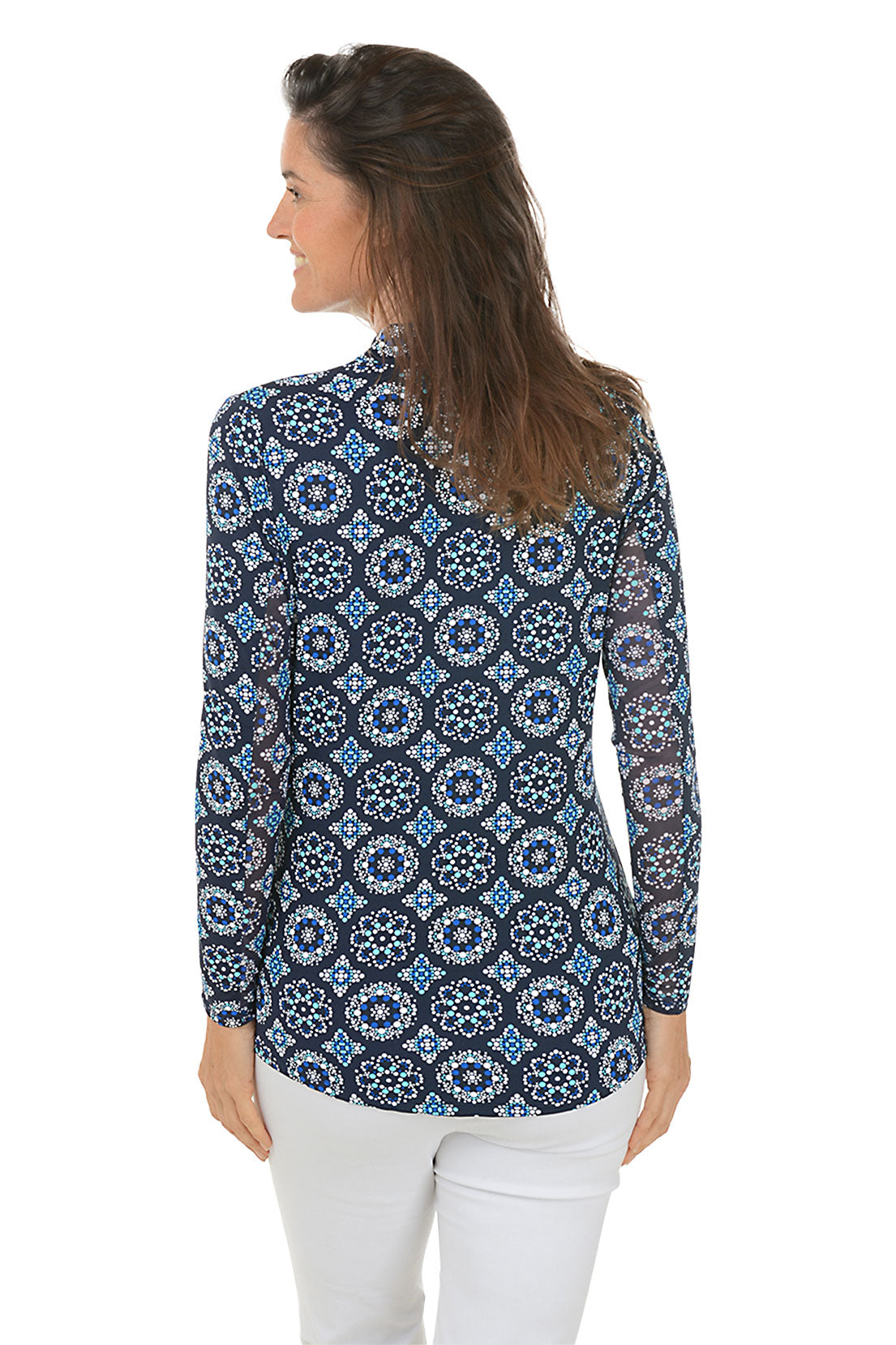 A back shot of a model wearing a mock neck, long sleeve top with a geometric pattern, in colors blue and white.