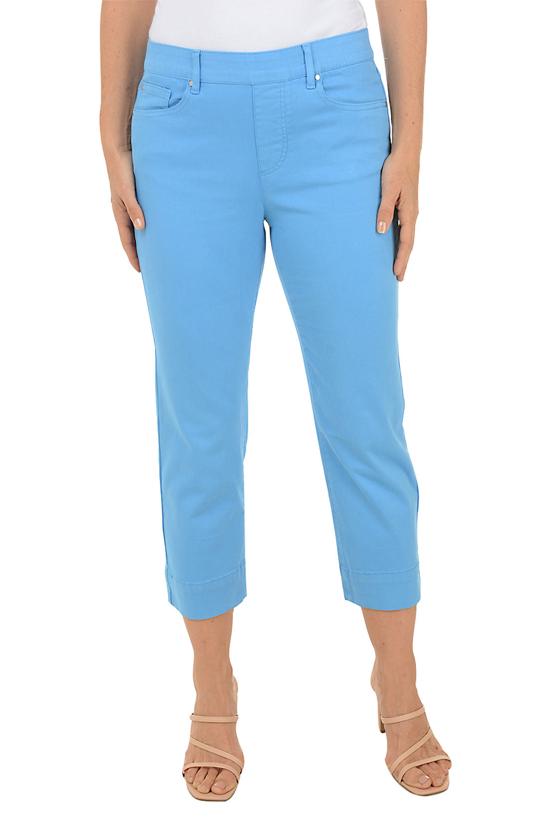 A front shot of a model wearing a pair of deep sea denim kick flare crop pants with a mid-rise waist and belt loops.