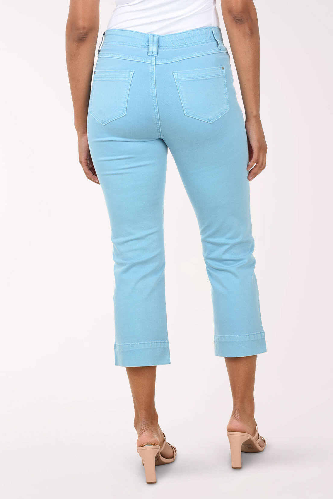 Light blue jeans worn by a person on a white background. Back shot