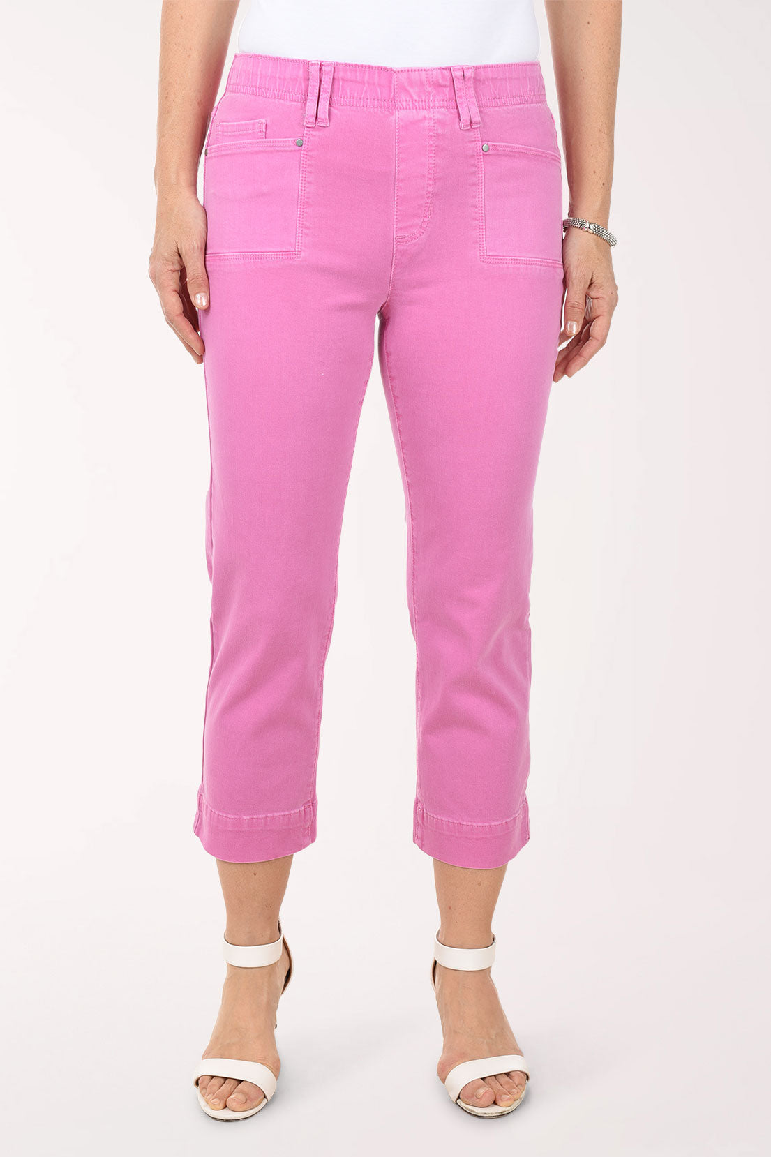 Person wearing bright pink pants on a white background