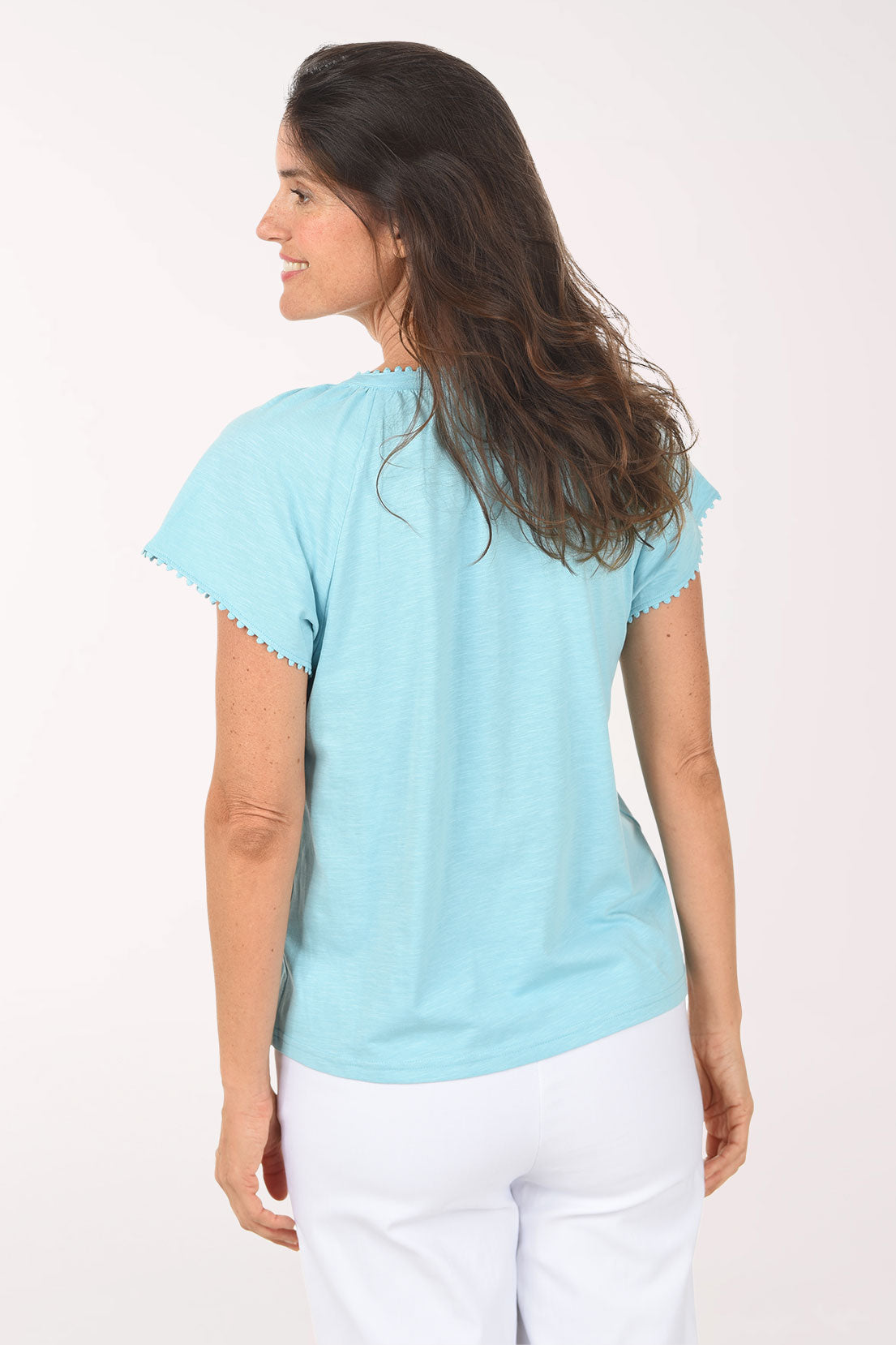 Woman wearing a light blue blouse with a white background