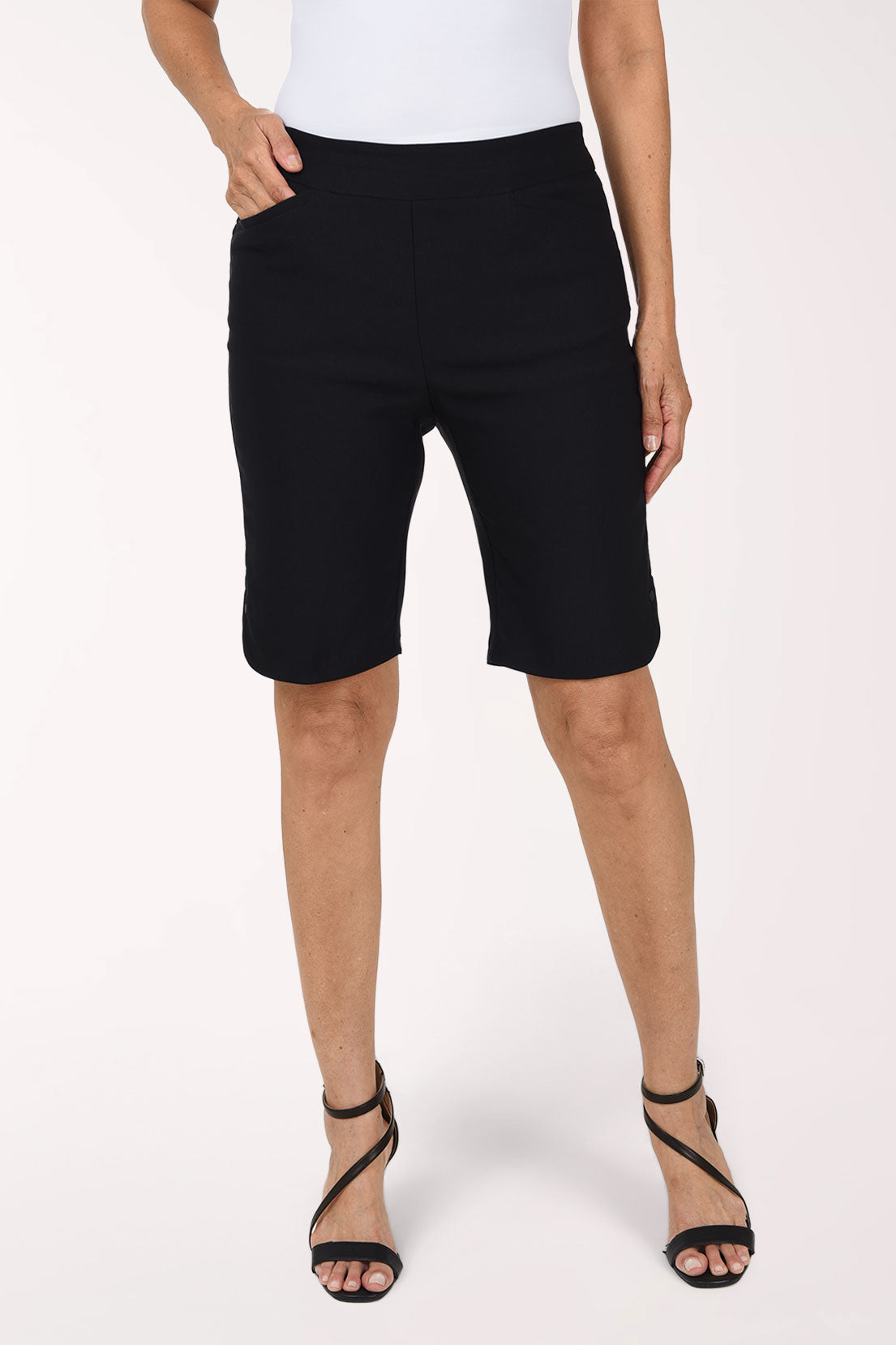 Woman wearing solid black bermuda shorts