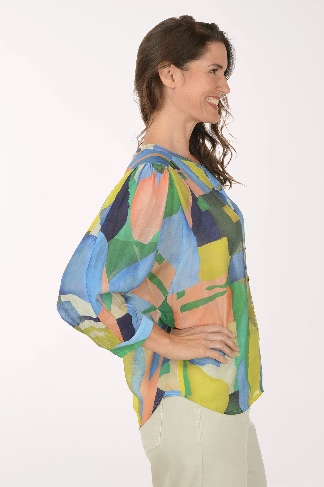Woman wearing a colorful abstract patterned shirt on a white background