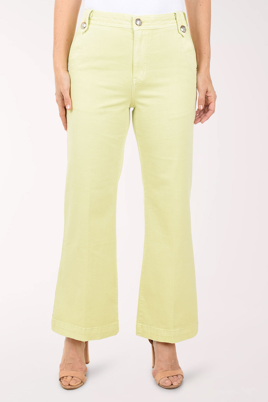 Light green pants worn by a person on a white background