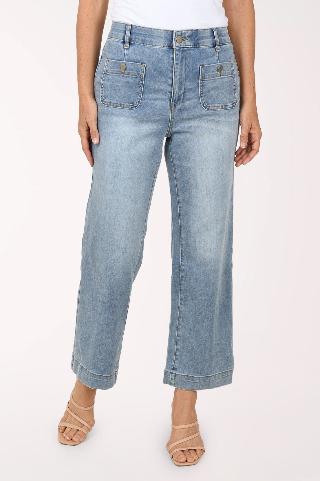 Front view of the light-wash Super Straight Patch Pocket Denim Pant showing the high-rise waistband with belt loops, zip fly with button, and buttoned front patch pockets, worn with a white top.