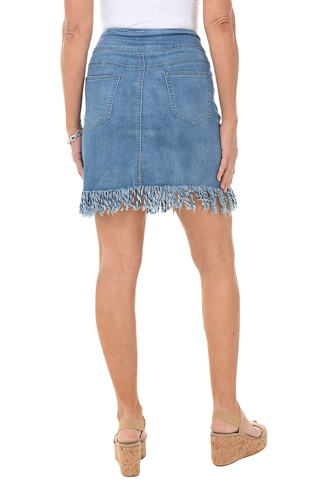 Denim skirt with fringed hem worn by a person on a white background. Back shot.