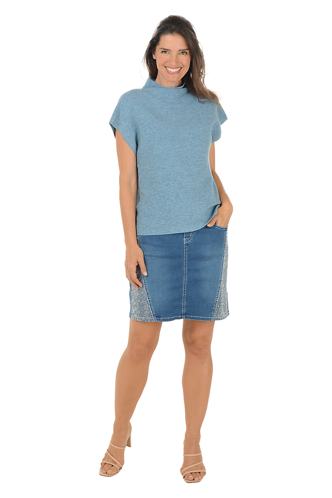 Woman wearing a blue top and denim skirt on a white background. Second front shot.