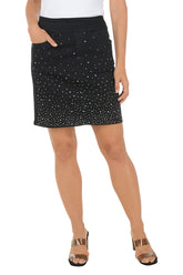 Black skirt with rhinestone embelishments worn by a person on a white background.