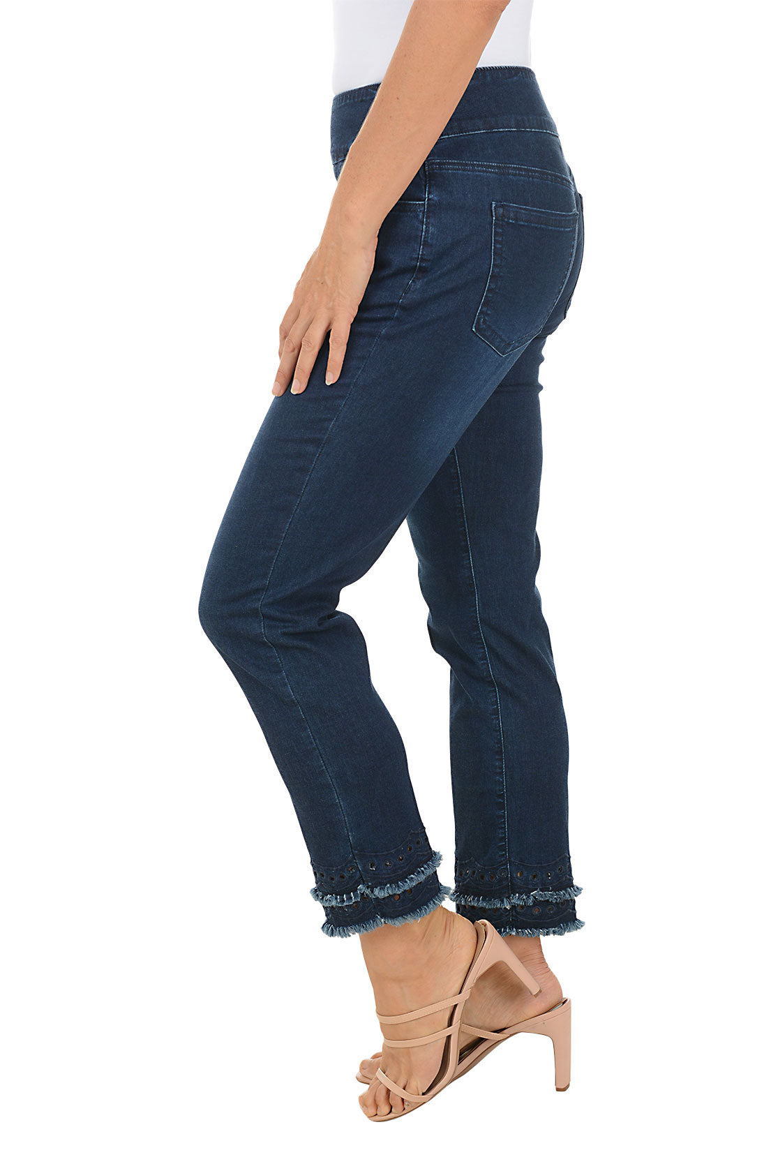 Person wearing dark blue jeans with a white background. Side shot.