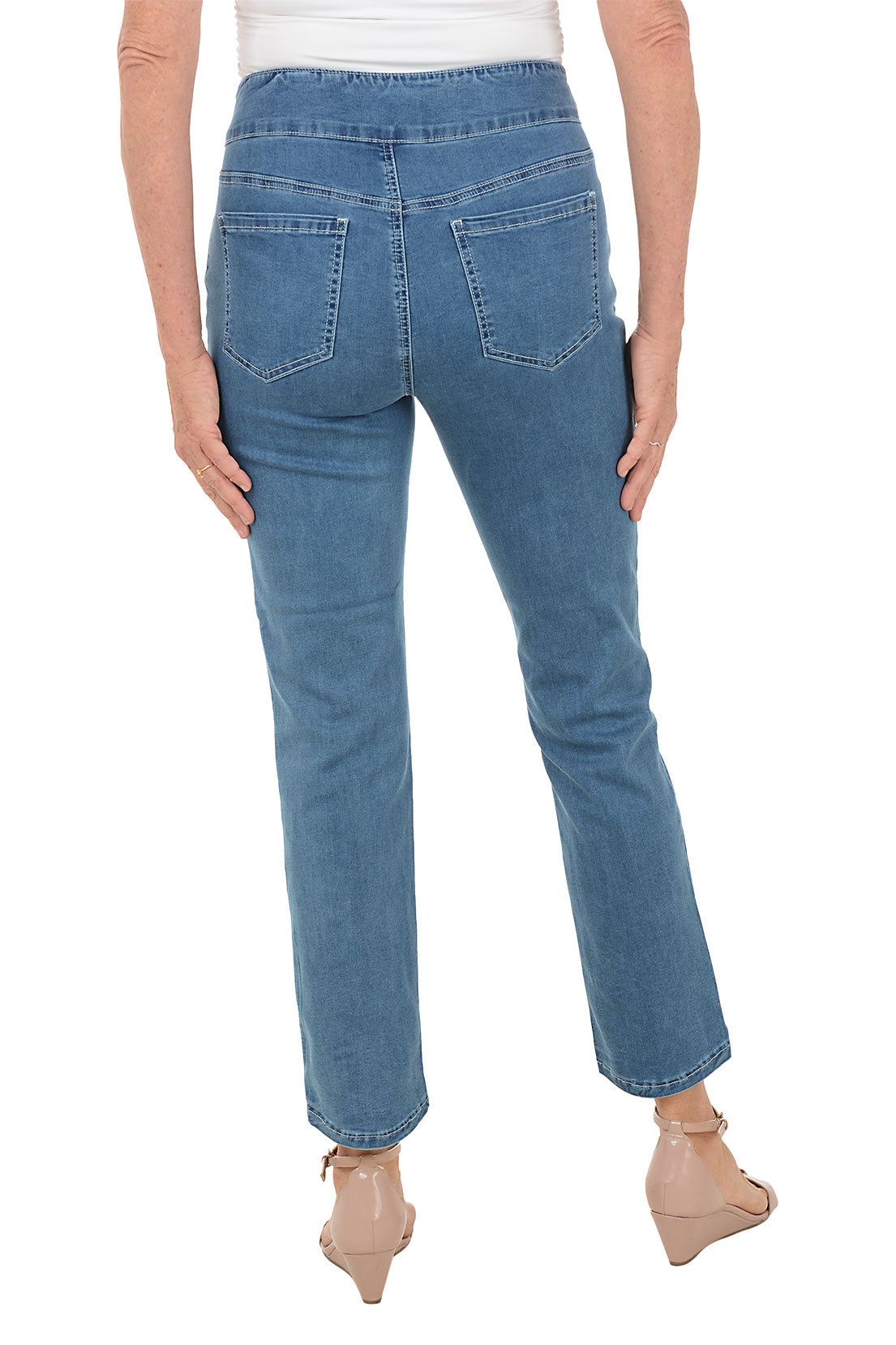 Blue jeans worn by a person on a white background. Back shot.