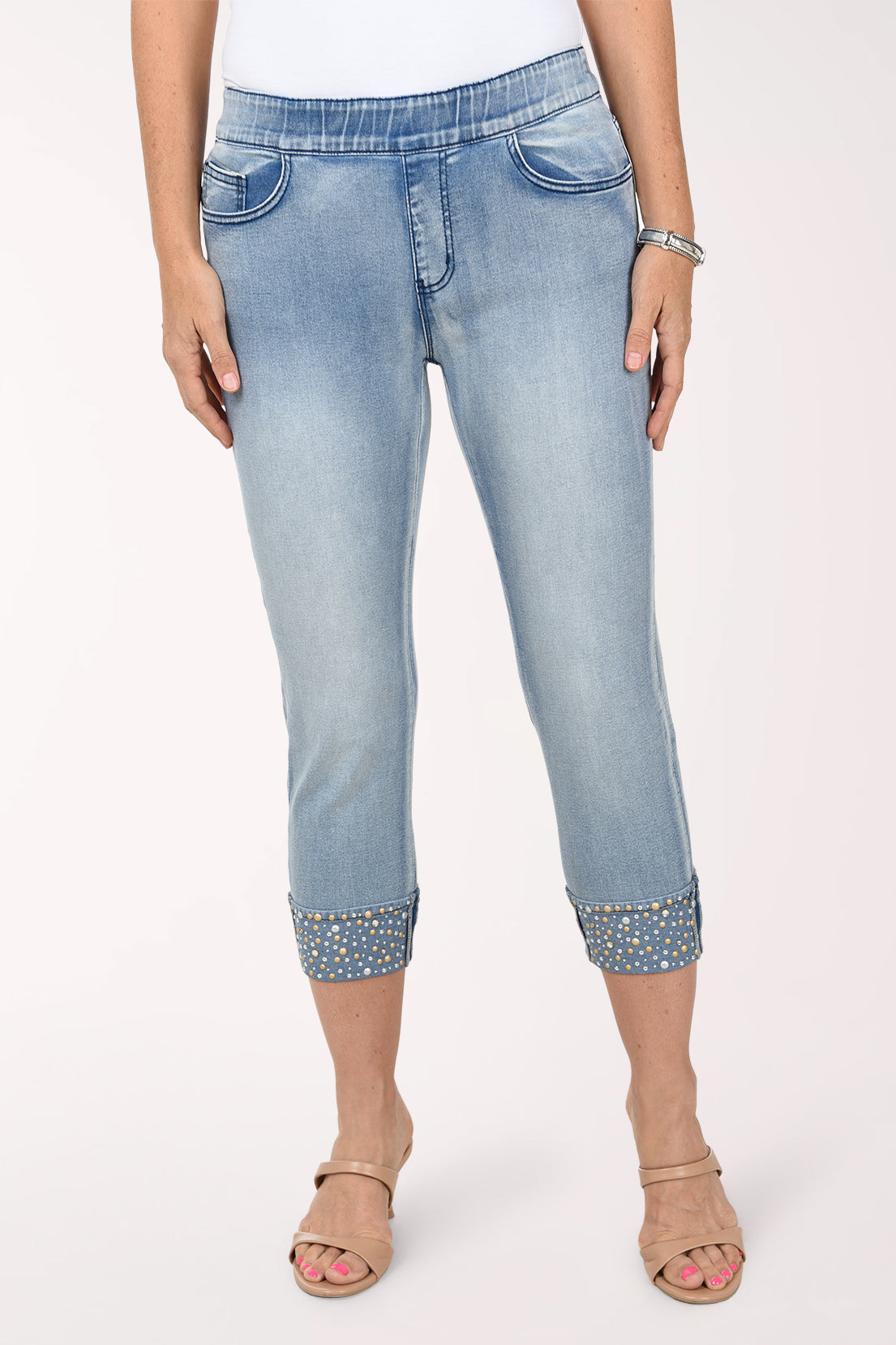 Front view of the light-wash jeweled cuff capris showing the stretch waistband, front pockets and sparkling cuffs below the knee.