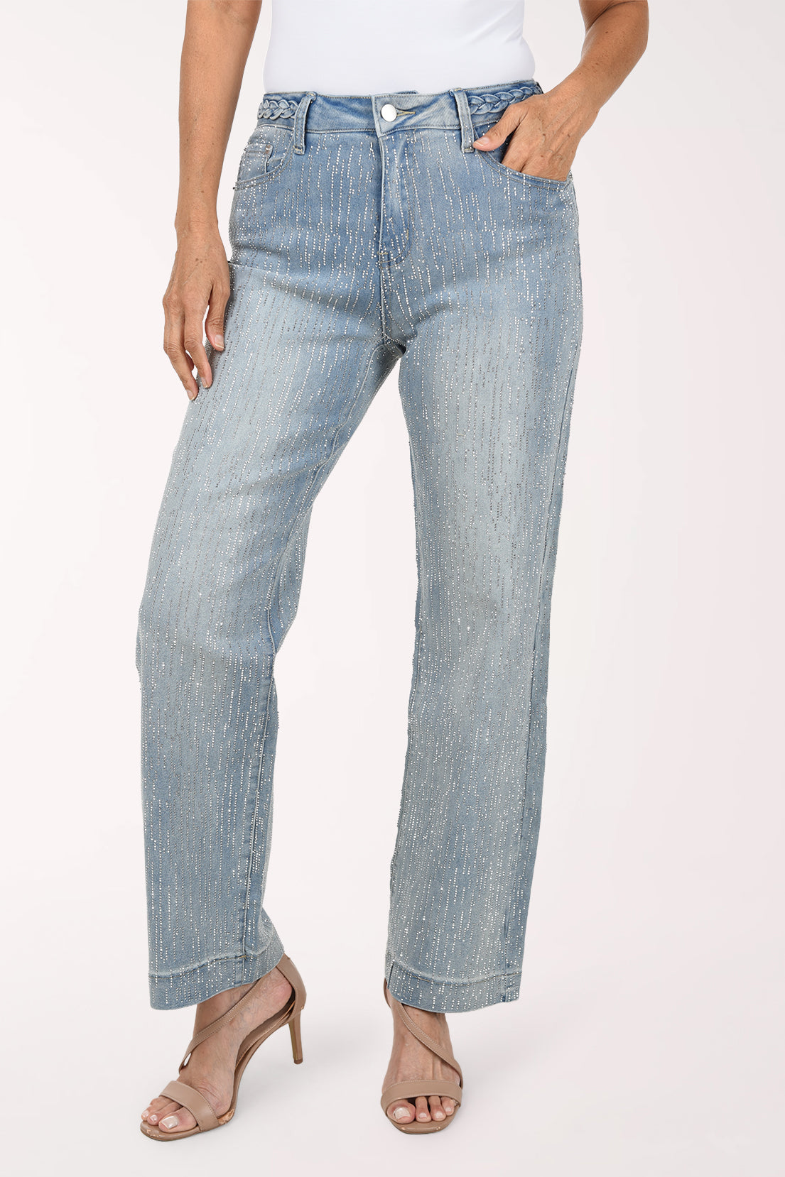 Front view of the light-wash rhinestone denim pants with one hand in the pocket, showing the full-length wide leg.