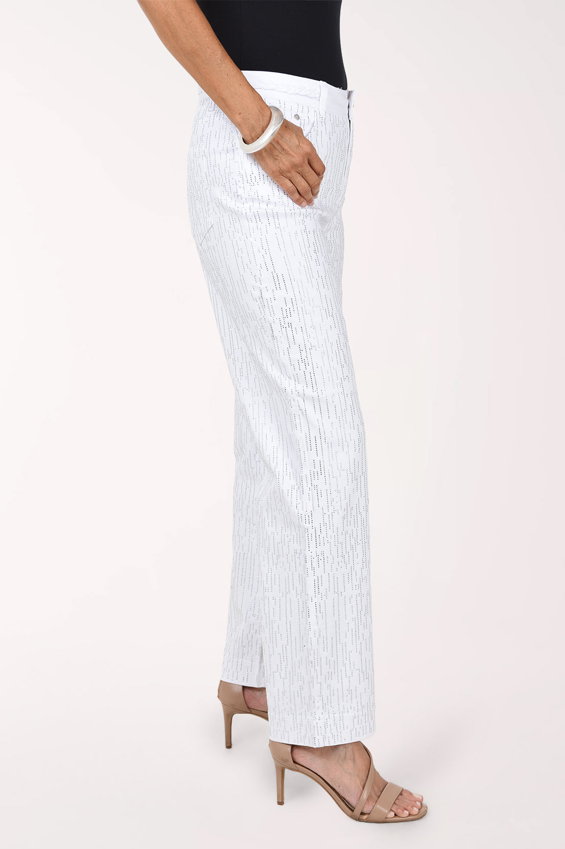 Side view of the white rhinestone denim pants showing the front pocket and full-length wide leg.